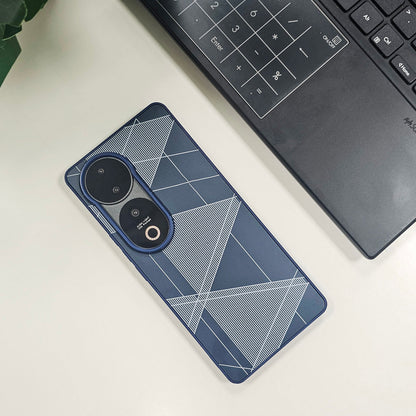 Phone case with geometric design on a white surface next to a laptop