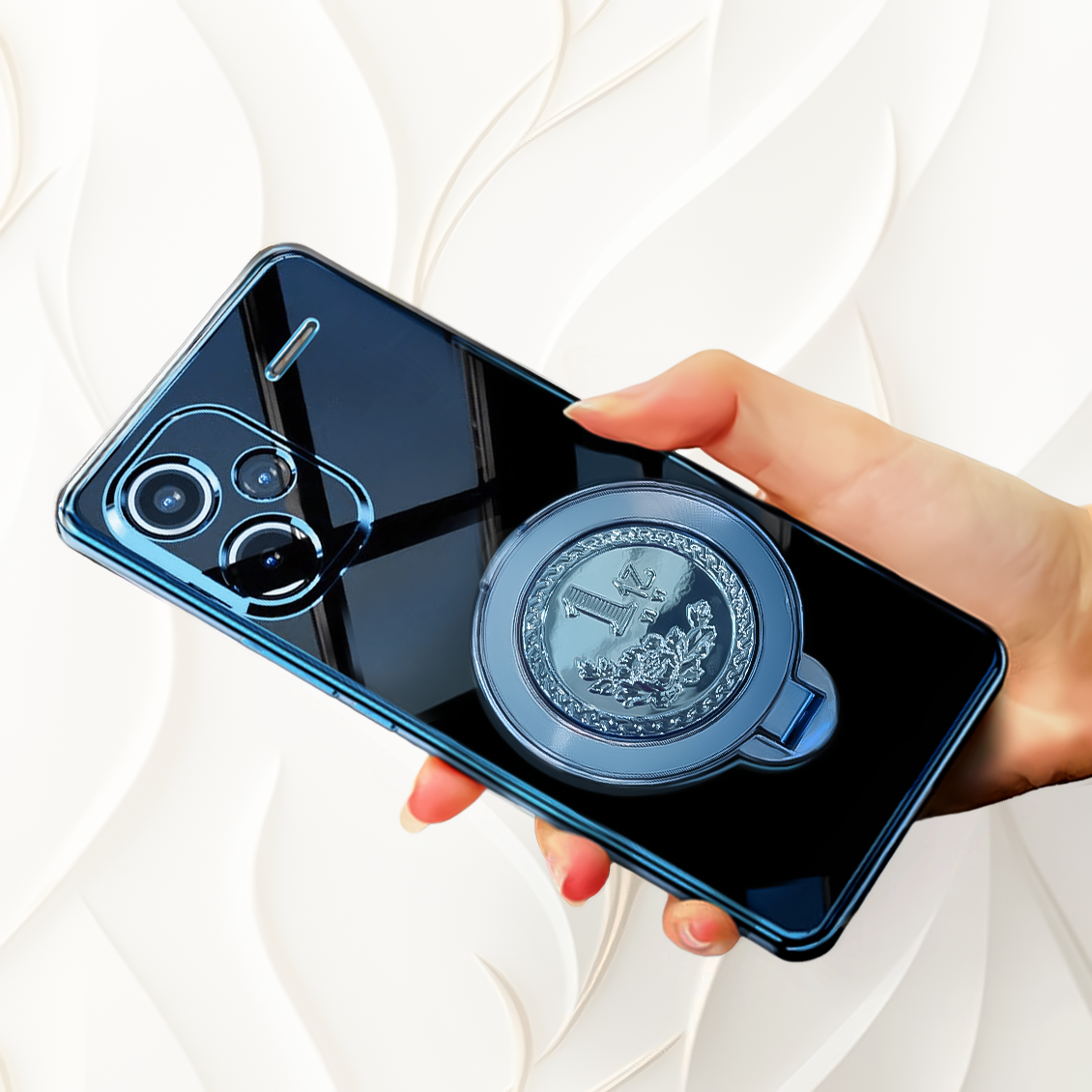 Hand holding a smartphone with a blue phone case featuring a crest design on a white background
