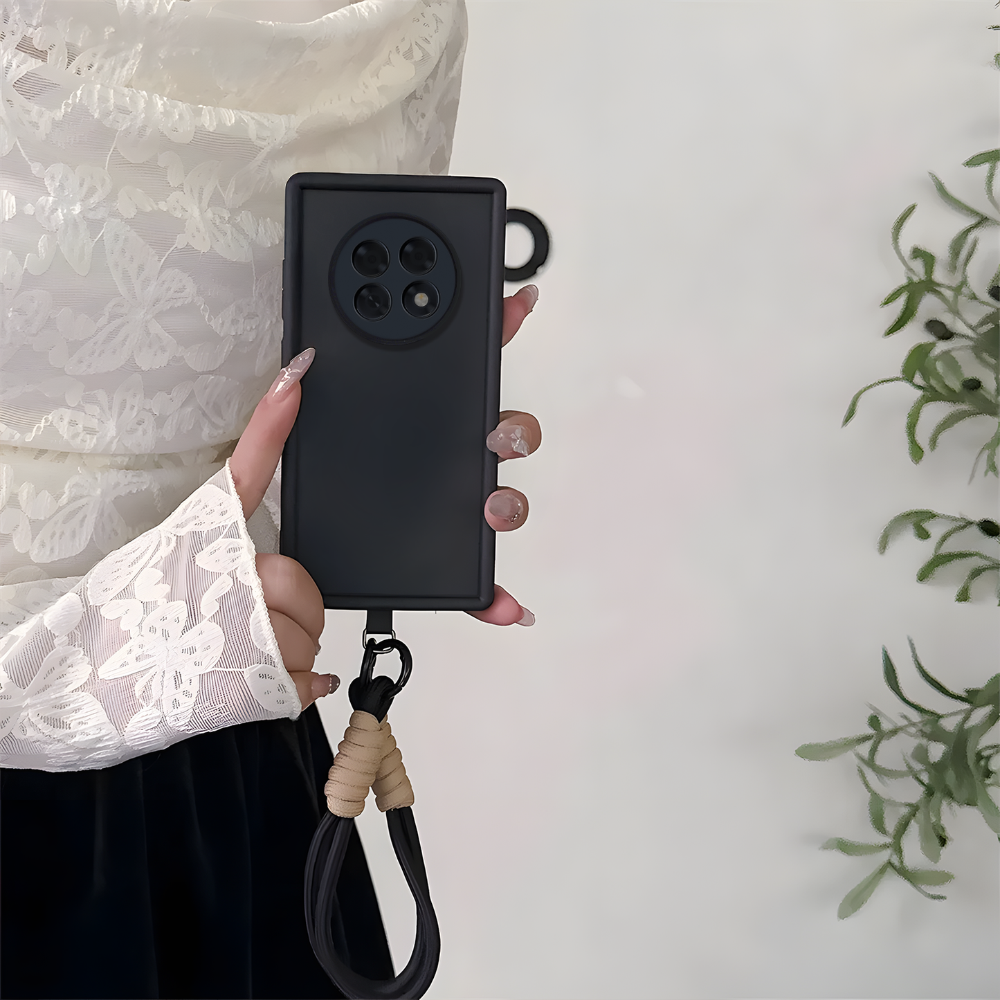 Person holding a black Oppo F31 Pro Plus 5G phone case with a lanyard on a light background