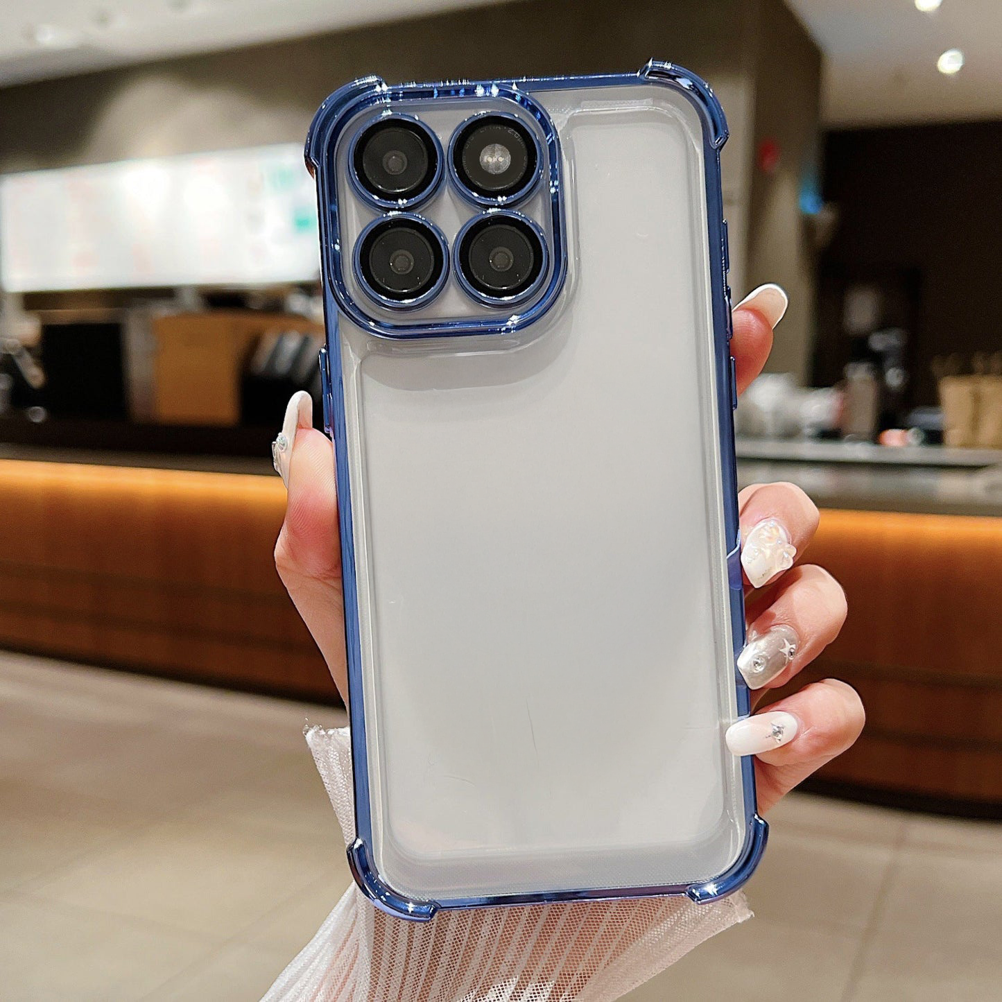 Person holding a phone case with a kitchen background