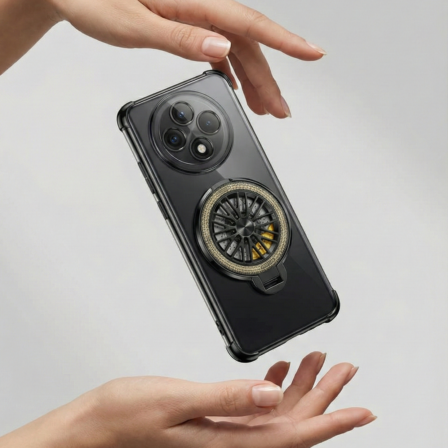 Phone case with car wheel design held by a hand on a light gray background