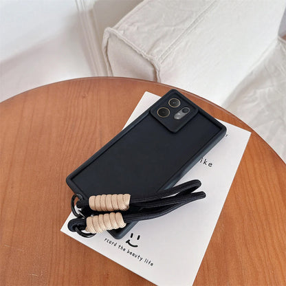 Vivo V60 5G Black phone case with a strap on a wooden table