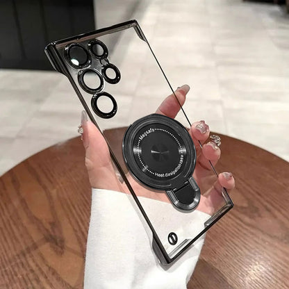 Samsung Galaxy S23 Ultra 5G Clear phone case with black camera lens protector and stand held by a hand on a wooden surface.
