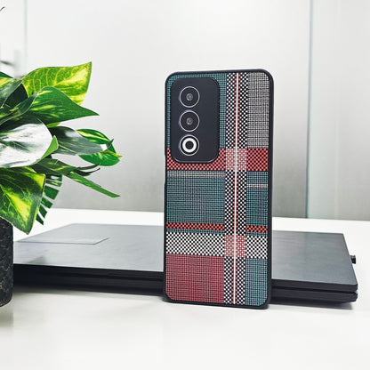 Phone case with geometric pattern on a white surface with a plant