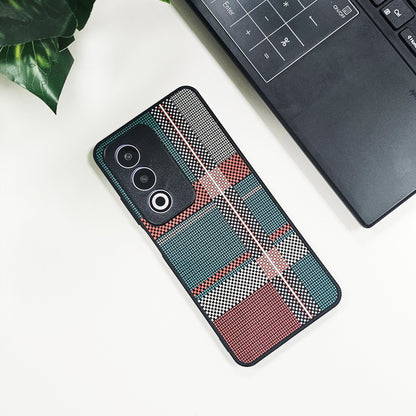 Phone case with geometric pattern on a white surface next to a laptop