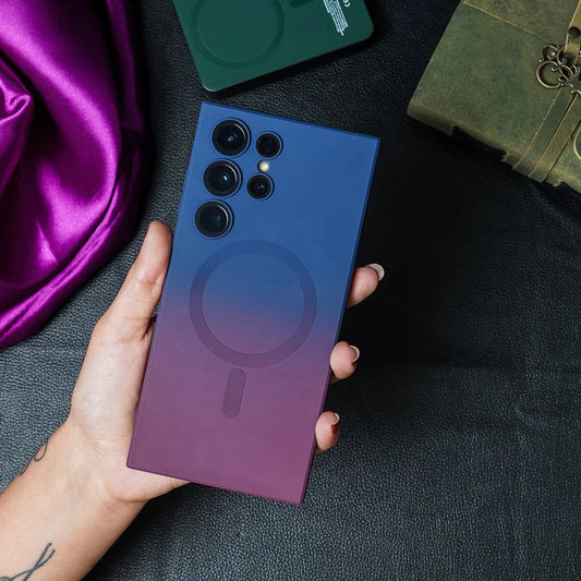 A hand holding a Samsung Galaxy S22 Ultra smartphone in a gradient purple and blue silicone MagSafe case.