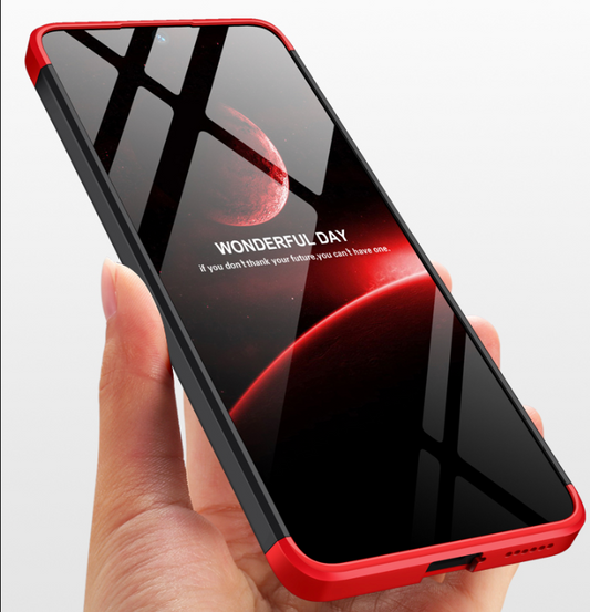 A hand holding a Redmi smartphone with a red and black matte back cover, displaying a colorful wallpaper on the screen.